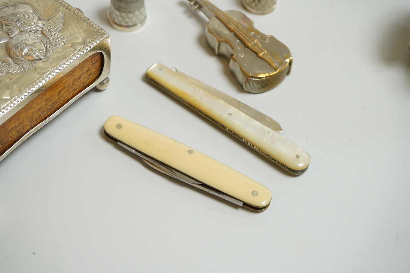 A small group of silver and other items, including an Edwardian silver mounted Common Prayer book(a.f.), a silver mounted matches holder, a silver mounted glass inkwell, a silver and mother of pearl fruit knife, two thim